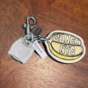 Coach  lemon bag charm  leather
Yellow/cream/white  inscribed “ Coach NYC”  NWT